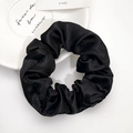 Elegant black satin scrunchie with silky texture on minimalist white decorative plate - Black (Large)