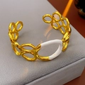 Detail of gold chain link bracelet featuring white enamel inlay on a velvet cushion - Bangle (WB1628) / Gold+White