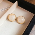 Detailed view of round beige marble textured stud earrings with gold wavy metal edges - Marble Pattern/Wavy Gold Edge