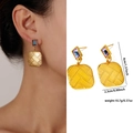 Golden square earrings with colorful gemstone and woven texture shown on a model - Zjge0484