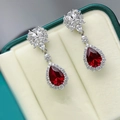 Elegant silver halo drop earrings with pear-cut red gemstones and sparkling white crystals - Red