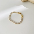 Dettaglio del bracciale tennis placcato oro 18k con zirconi baguette e chiusura sicura - Bracciale