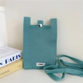 Detail of mint green knitted phone bag featuring a silver snap button closure - Lake Blue