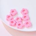 Pink 19mm floral acrylic beads for DIY jewelry making scattered on a white plate - Solid Pink