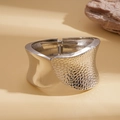 Detail of silver hinge bracelet featuring smooth mirror finish and hammered texture - Silver
