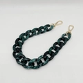 Close-up of dark green acrylic bag chain with marble pattern and gold lobster clasps - Dark Green & White