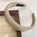 Detail of a beige satin headband with a thick profile and handmade inner label - Light Khaki