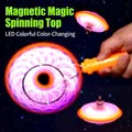 Orange magnetic LED fidget spinner with handle showing colorful light effects in dark - Magnetic Rail Light-Up Gyro