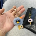 Close-up detail of a cute blue plush ice cream cone keychain with a gold metal hook - Single Piece / Blue