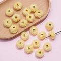 Detail of 20mm soft faux rabbit fur pompoms with gold metal eyelets for DIY crafts - Yellow