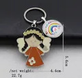 Detailed view of angel keychain with rainbow charm featuring Schulkind 123 abc text - Orange Red