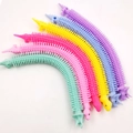 Rainbow unicorn fidget bracelets in six vibrant colors made of stretchy TPR soft rubber - Dinosaur Stretch Toy