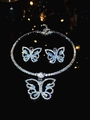 Macro shot of silver butterfly jewelry set with sparkling rhinestones on black background - Silver Butterfly Jewelry Set