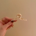 Elegant beige minimalist hair claw clip held by hand against a soft cream background - Small 7.5cm / Milky White