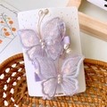 Detail of lavender mesh butterfly hair clips with sparkling sequins and pearl accents - Purple