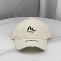 Detail of embroidered 'M' patch and DESTINATION text on distressed beige baseball cap - One Size (58-60cm) / Beige
