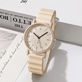 Detail of cream round quartz watch with wavy silicone strap on minimalist white steps - Light Yellow