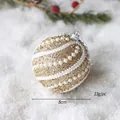 8cm gold Christmas ball ornament with white pearls and lace on a snowy pine background - Gold