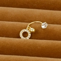Macro shot of gold-plated flower belly ring with clear cubic zirconia on a velvet display tray - Hollow Circle Style (Y20370-13)