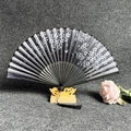 Classic folding fan with black and white gradient, floral pattern and black tassel detail - Cherry Blossoms Floating - Black Handle