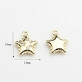Detailed view of gold star charms with cubic zirconia inlay and 15mm size dimensions - Star / Gold
