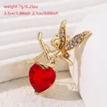 Golden fairy brooch featuring a large red heart gemstone and white crystal wings - Heart Gem Fairy (KC0027) / Gold