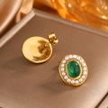 Macro view of vintage gold stud earrings with green gemstones and pearl borders - Oval Pearl / Gold + Green Cat Eye