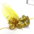 Luxurious gold masquerade mask featuring vibrant yellow feathers and floral accents - Gold
