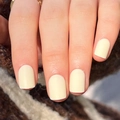 Short round press-on nails in matte cream beige color shown on a knit background - Glue Type / Matte Cream (JP3180)