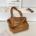Detail of brown canvas tote with adjustable shoulder strap and dream lettering print - Apricot Yellow