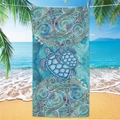 Detail of microfiber beach towel featuring turtle prints hanging on a palm tree - Sea Turtle Beach Towel 17