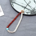 Beaded phone strap with red and white pearls, blue stone detail and black woven cord - Red Agate + Bodhi Beads (K3442)