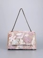 Detailed close-up of floral embroidery and sequins on a woven straw shoulder bag - Pink