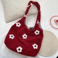 Close-up of a red fuzzy tote bag with white floral embroidery and checkered lining - Flower Red