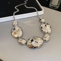 Macro shot of silver lava irregular metal beads on a necklace with a liquid metal finish - Necklace / Silver