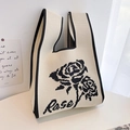 Detailed view of off-white knitted tote bag with black rose pattern and textile texture - Beige Single Rose