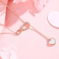 Close-up of rose gold infinity necklace with heart-shaped mother of pearl pendant - Infinity Love Zirconia Necklace - Gold