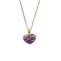 Detailed close-up of wire-wrapped heart amethyst pendant on a golden chain necklace - Amethyst