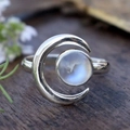 Elegant silver moon ring featuring a round glowing moonstone and hollow crescent design - Adjustable Open / Antique Silver