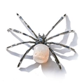 Macro detail of silver spider ornament featuring a large irregular white crystal stone body - Irregular White Agate