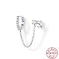 Macro shot of S925 sterling silver chain earrings with sparkling white zircon stones - 925 Silver / Silver-White Zirconia