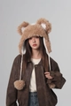Detailed texture of fluffy light brown faux fur earflap hat with cute bear ears and poms - Khaki
