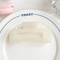 Minimalist matte cream hair claw clip for women displayed on a ceramic plate - 10.5cm / Off White