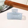 Close-up of a large rectangular hair claw clip with a pearlescent light blue shell texture - PVC 7.5cm Rectangular - Iridescent Blue