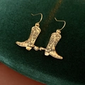Detailed view of vintage gold cowboy boot earrings with floral engraving and spurs on velvet - Ear Hook - Gold