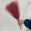 Close-up of hand holding a 55cm deep pink artificial pampas grass bouquet for boho decor - 53-55cm / Light Purple