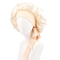 Close-up of champagne satin bonnet with elastic wide band and adjustable ribbon ties - Champagne