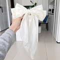 Elegant oversized white satin bow hair clip with a smooth glossy silk finish - Off-white