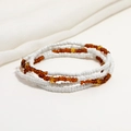 Close-up of double-layered white and amber glass seed beads on a white fabric background - 80cm / White/Amber