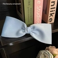Detail of light blue satin bow hair clip with elegant silk texture and neat pleats - Light Blue Simple Bow Duckbill Clip